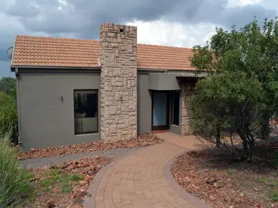 a house with a brick walkway in front of it at Elements Private Golf Reserve in Bela-Bela