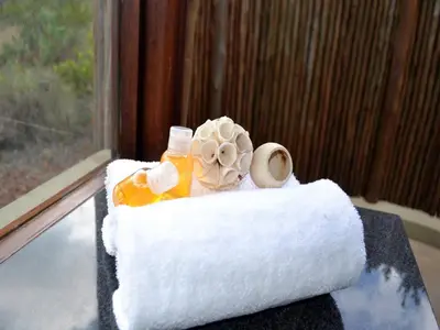 a cake with towels and a flower on a table at Elements Private Golf Reserve in Bela-Bela