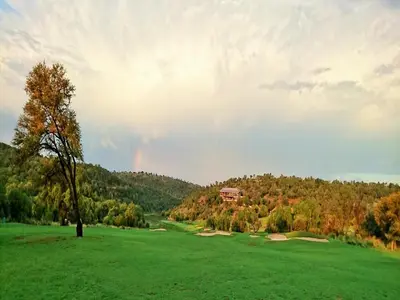 a rainbow over a golf course with a green field at Elements Private Golf Reserve in Bela-Bela