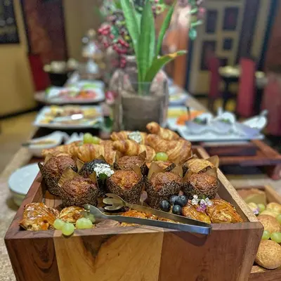 a buffet of food with pastries and other foods on a table at Cycad Guest House in Polokwane