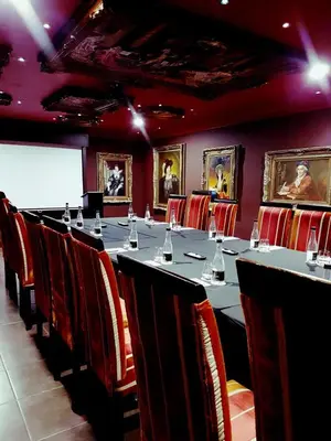 a conference room with a long table and chairs at Cycad Guest House in Polokwane