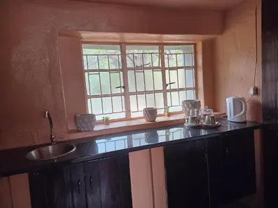 a kitchen with a sink and a window at Three Bridges B&B in Hoedspruit