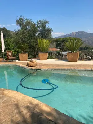 a swimming pool with a hose in the water at Ithaba Falls Guest Farm Farm L59, Buffelsvley, Burgersfort, 1150 in Boerboomskraal