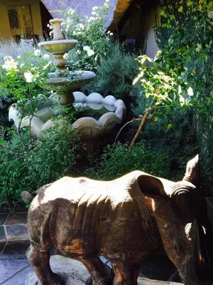 a statue of a dog next to a fountain at Ithaba Falls Guest Farm Farm L59, Buffelsvley, Burgersfort, 1150 in Boerboomskraal