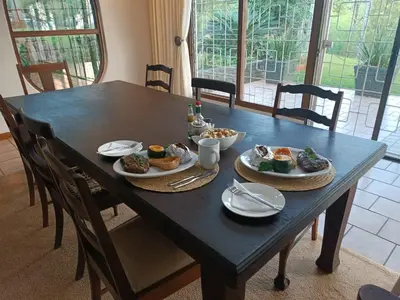 a black table with plates of food on it at Pecan Farm Guesthouse in Louis Trichardt