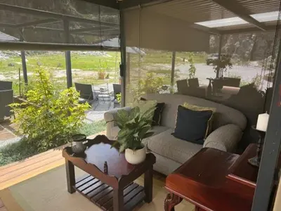 a living room with a couch and a table at Plumbago Guest House in Hazyview