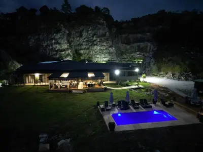 an aerial view of a house with a swimming pool at night at Plumbago Guest House in Hazyview