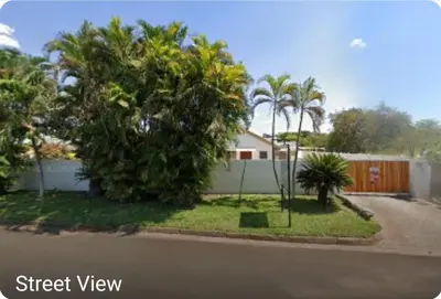 a street view of a house with trees and a fence at Lani's Guest House - No Loadshedding in Musina
