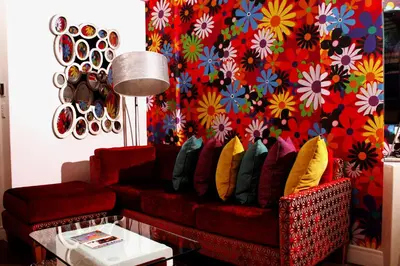 a living room with a red couch with colorful pillows at Peermont Metcourt - Thaba Moshate in Burgersfort