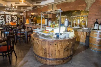 a restaurant with a large wooden barrel in the middle at The Centurion Hotel in Centurion