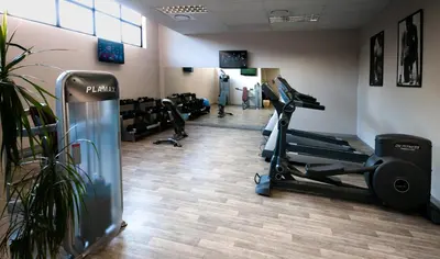 a gym with treadmills and tread machines in a room at The Centurion Hotel in Centurion