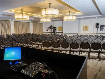 a conference room with chairs and a computer on a table at The Centurion Hotel in Centurion
