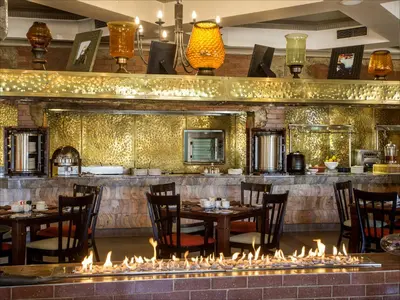 a restaurant with tables and chairs and fireplaces at The Centurion Hotel in Centurion