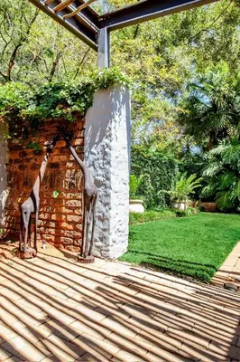 a statue of a giraffe eating leaves from a wall at Waters on Willows in Pretoria