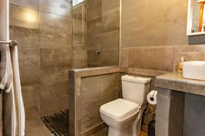 a bathroom with a toilet and a sink at Waters on Willows in Pretoria