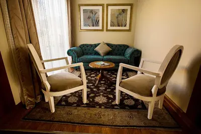 a living room with two chairs and a couch at Mavuta Manor in Polokwane