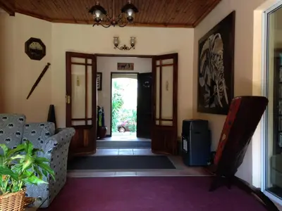 a hallway with a door open to a living room at Ipe Tombe Guest Lodge - Midrand in Midrand