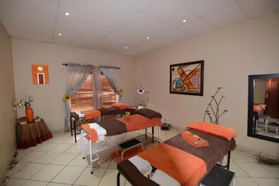 a room with four beds and a window at Attaché Guest Lodge & Health Spa in Midrand