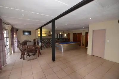 a living room with a pool in the middle of it at Attaché Guest Lodge & Health Spa in Midrand