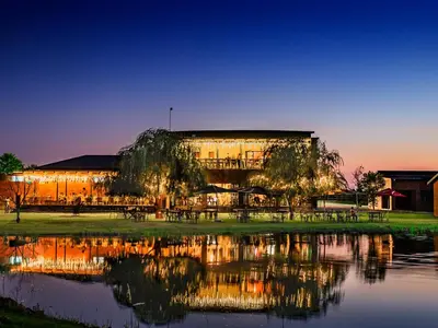 a building with a reflection in the water at Rustique Boutique Hotel in Middelburg