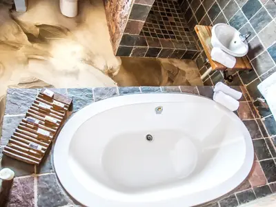 a bathroom with a white toilet in a room at Rustique Boutique Hotel in Middelburg