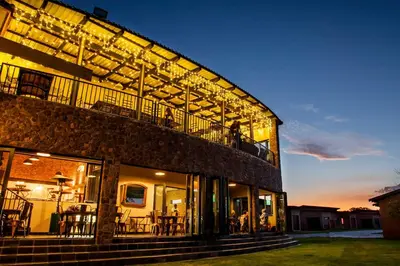 a building with a balcony with tables and chairs at Rustique Boutique Hotel in Middelburg