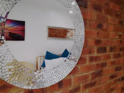 a mirror on the side of a brick wall at Limonite GuestHouse in Pretoria