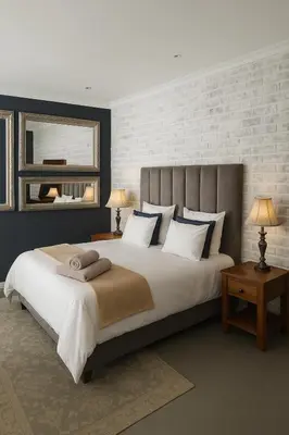 a bedroom with a large white bed with a mirror at Limonite GuestHouse in Pretoria