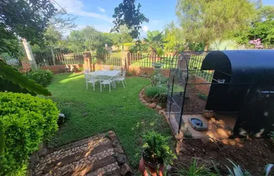 a backyard with a grill and a table in the yard at Big Boma Guest House in Lydenburg