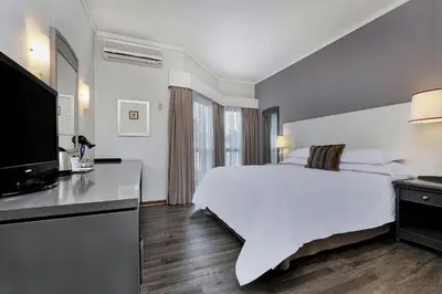 a hotel room with a bed and a flat screen tv at Protea Hotel by Marriott Midrand in Midrand