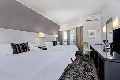 a hotel room with two beds and a television at Protea Hotel by Marriott Midrand in Midrand