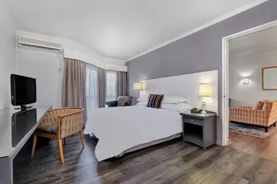 a hotel room with a large bed and a television at Protea Hotel by Marriott Midrand in Midrand