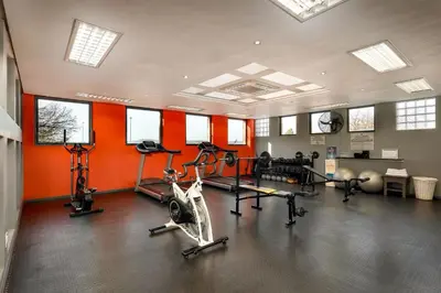 a gym with bikes and exercise equipment in a room at Protea Hotel by Marriott Midrand in Midrand