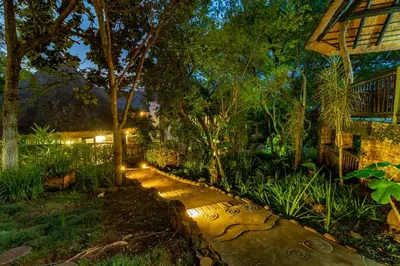 a garden at night with a stone path at Blue Jay Lodge in Hazyview