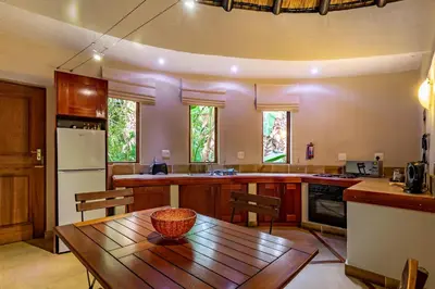 a kitchen with a wooden table in a room at Blue Jay Lodge in Hazyview