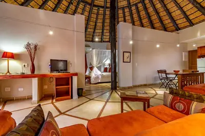 a living room with a couch and a table at Blue Jay Lodge in Hazyview