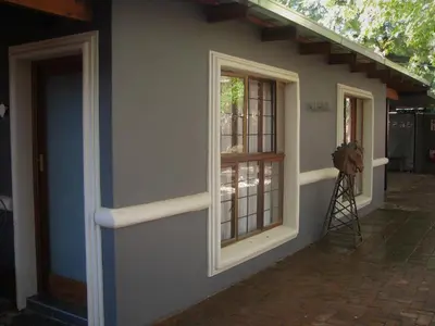 a house with two windows on the side of it at The Village in Hatfield in Pretoria