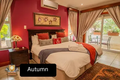 a bedroom with a large bed with red walls at All Seasons Boutique Hotel - Sustainable Electricity and Water in Pretoria