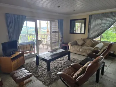 a living room with a couch and a tv at All Seasons Boutique Hotel - Sustainable Electricity and Water in Pretoria