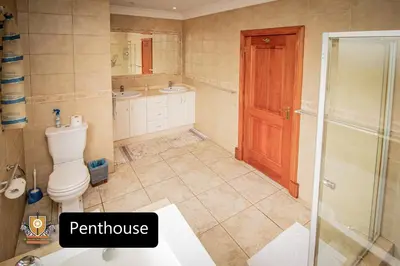 a bathroom with a toilet and a shower and a sink at All Seasons Boutique Hotel - Sustainable Electricity and Water in Pretoria