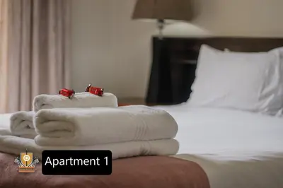a pile of towels sitting on top of a bed at All Seasons Boutique Hotel - Sustainable Electricity and Water in Pretoria