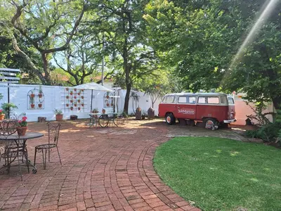 an old red van parked in a yard at 3@Marion Guest House in Pretoria