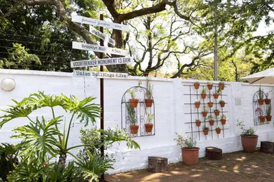 a sign with street signs and potted plants at 3@Marion Guest House in Pretoria