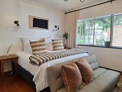 a hotel room with a bed and a couch at 3@Marion Guest House in Pretoria