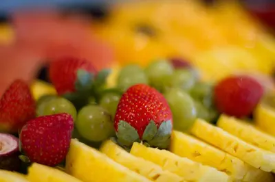 a plate of fruit with strawberries and green grapes at City Lodge Hotel at OR Tambo International Airport in Kempton Park