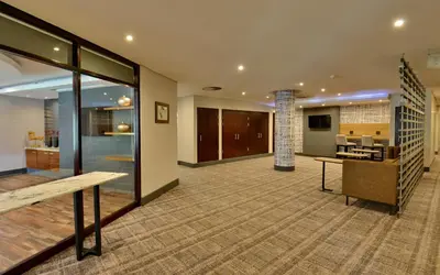 an empty lobby with a bench and a fireplace at City Lodge Hotel Lynnwood in Pretoria