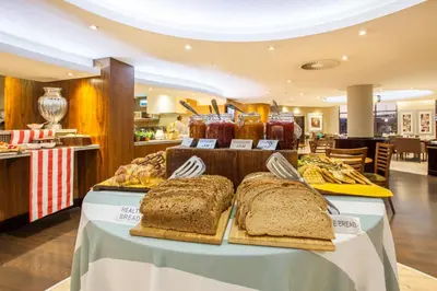 a table with bread and other food items on it at City Lodge Hotel Lynnwood in Pretoria