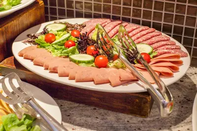 a plate of food with meat and a salad at City Lodge Hotel Lynnwood in Pretoria