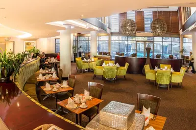 a restaurant with tables and chairs and a bar at City Lodge Hotel Lynnwood in Pretoria