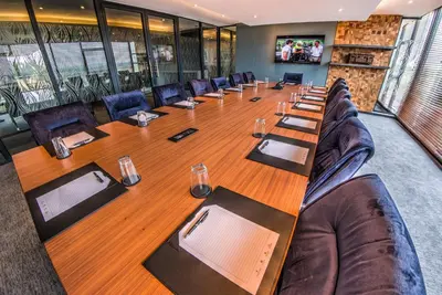 a large conference room with a long table and chairs at City Lodge Hotel Waterfall City in Midrand